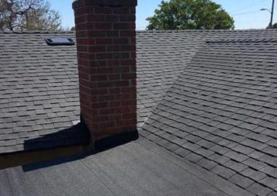Residential roofing installed around a chimney by Gotcha Covered Roofing Company